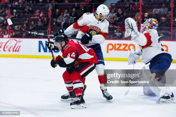 Ottawa Senators Center Jean-Gabriel Pageau ducks as Florida Panthers Defenceman Aaron Ekblad is hit by a shot in front of Florida Panthers Goalie...