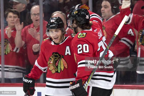 Patrick Kane and Brandon Saad of the Chicago Blackhawks celebrate after Saad scored against the Winnipeg Jets in the first period at the United...