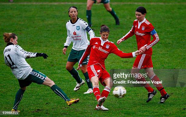 Sandra de Pol and Stefanie Mirlach of Bayern battle for the ball with Simone Laudehr and Annike Krahn of Duisburg during the Women's Bundesliga match...