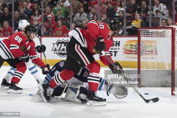 Brandon Saad of the Chicago Blackhawks scores against the Winnipeg Jets in the first period at the United Center on March 29, 2018 in Chicago,...