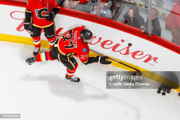 Dougie Hamilton of the Calgary Flames practices his puck handling skills at warm up in an NHL game on March 29, 2018 at the Scotiabank Saddledome in...