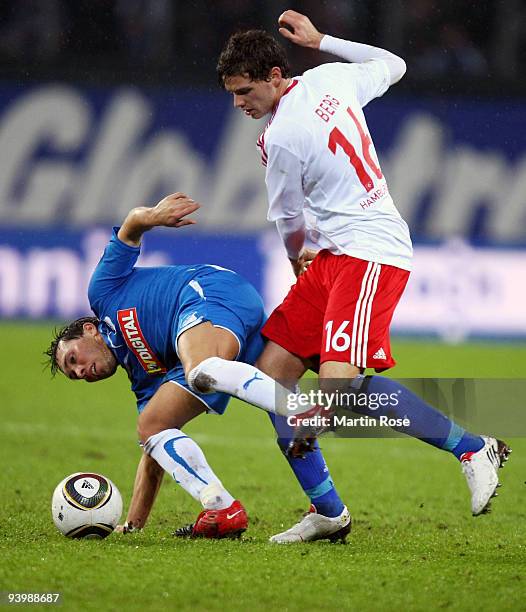 Marcus Berg of Hamburg and Tobias Weis of Hoffenheim battle for the ball during the Bundesliga match between Hamburger SV and 1899 Hoffenheim at the...