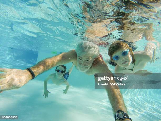 children, father, and grandfather swim underwater - bath relaxation stock pictures, royalty-free photos & images