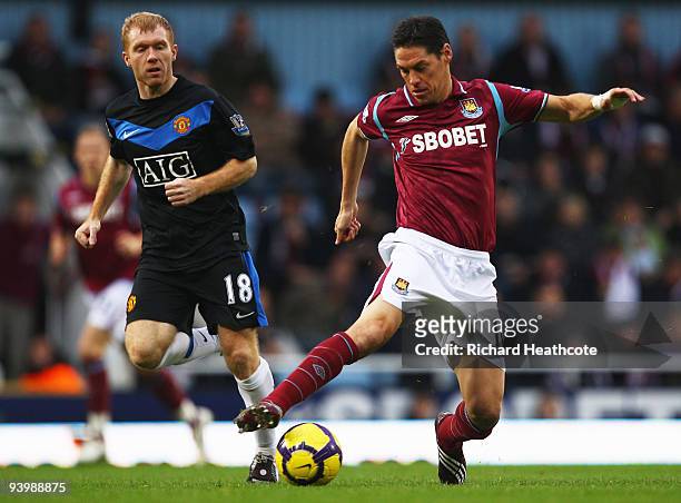Guillermo Franco of West Ham United is watched by Paul Scholes of Manchester United during the Barclays Premier League match between West Ham United...