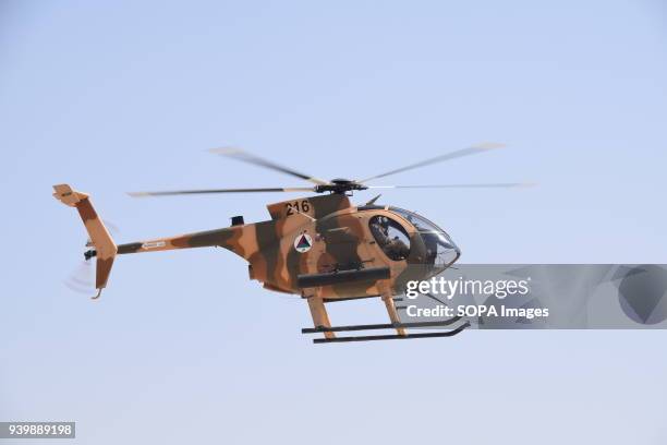Cayuse Warrior light attack helicopter of the Afghan Air Force flying in the sky over the Kabul Military Training Centre , during an exercise.