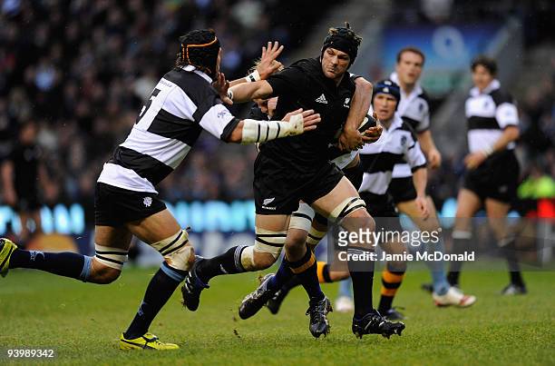 Richie McCaw of New Zealand holds off Victor Matfield of Barbarians during the MasterCard Trophy match between Barbarians and New Zealand at...