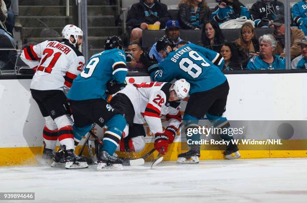 Logan Couture and Mikkel Boedker of the San Jose Sharks battle for the puck against Kyle Palmieri and Damon Severson of the New Jersey Devils at SAP...