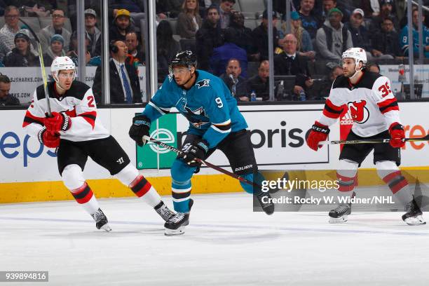 Evander Kane of the San Jose Sharks skates against John Moore of the New Jersey Devils at SAP Center on March 20, 2018 in San Jose, California....