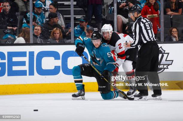 Chris Tierney of the San Jose Sharks skates against John Moore of the New Jersey Devils at SAP Center on March 20, 2018 in San Jose, California....