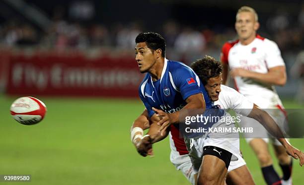 Samoa's Alafoti Faosiliva is challenged by England's Mat Turner during their IRB Rugby Sevens World Series semi-final match in the Gulf emirate of...