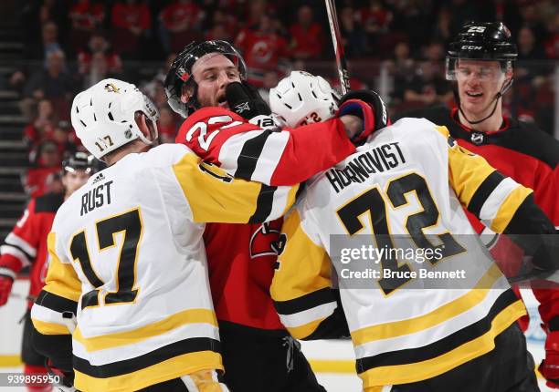 Bryan Rust and Patric Hornqvist of the Pittsburgh Penguins go up against Stefan Noesen of the New Jersey Devils during the third period at the...