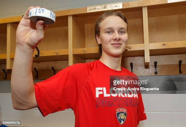After his NHL debut against the Ottawa Senators, Henrik Borgstrom of the Florida Panthers poses for a photo with the game puck in the locker room at...