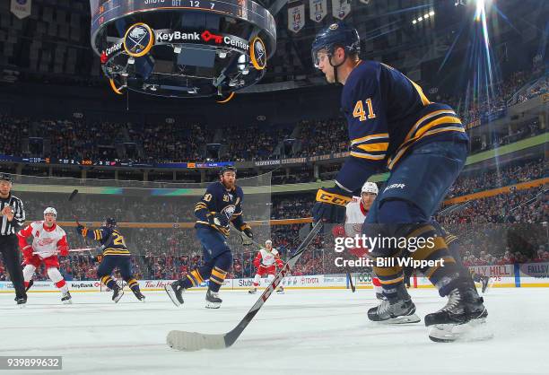 Justin Falk of the Buffalo Sabres looks to pass the puck against the Detroit Red Wings during an NHL game on March 29, 2018 at KeyBank Center in...