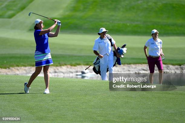 Juli Inkster makes an approach shot as Catriona Matthew of Scotland and her caddie look on on the sixth hole during round one of the ANA Inspiration...