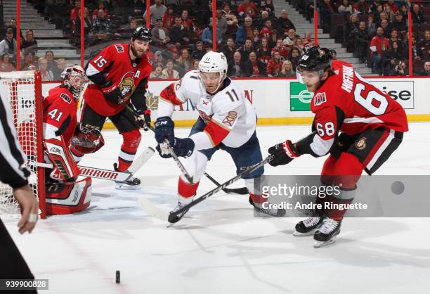 Jonathan Huberdeau of the Florida Panthers battles for a loose puck against Craig Anderson, Zack Smith and Mike Hoffman of the Ottawa Senators at...