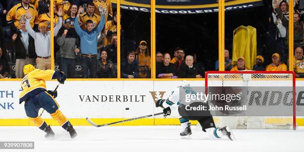 Nick Bonino of the Nashville Predators scores and empty net goal against Logan Couture of the San Jose Sharks for a 5-3 win during an NHL game at...