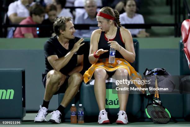 Coach David Taylor confers with Jelena Ostapenko of Latvia on a changeover against Danielle Collins during the semifinals of the Miami Open Presented...