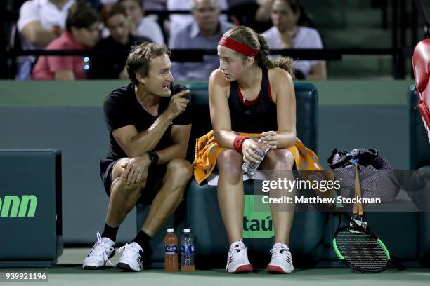 Coach David Taylor confers with Jelena Ostapenko of Latvia on a changeover against Danielle Collins during the semifinals of the Miami Open Presented...