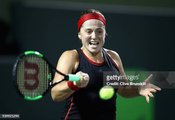 Jelena Ostapenko of Latvia plays a forehand against Danielle Collins of the United States in their semifinal during the Miami Open Presented by Itau...