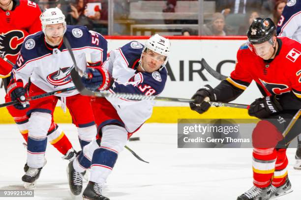 Boone Jenner of the Columbus Blue Jackets shoots the puck in an NHL game on March 29, 2018 at the Scotiabank Saddledome in Calgary, Alberta, Canada.