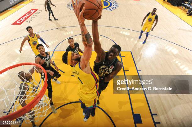 JaVale McGee of the Golden State Warriors blocks a shot from Tony Snell of the Milwaukee Bucks during the game on March 29, 2018 at ORACLE Arena in...