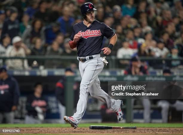 Lonnie Chisenhall of the Cleveland Indians crosses home plate to score a run on a single by Yan Gomes of the Cleveland Indians during the seventh...
