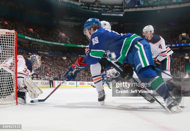 Adam Gaudette of the Vancouver Canucks takes a shot against Cam Talbot of the Edmonton Oilers during their NHL game at Rogers Arena March 29, 2018 in...