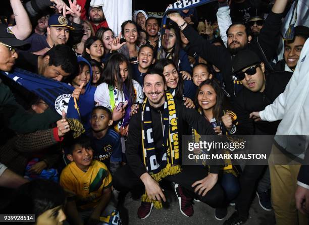 Football star Zlatan Ibrahimovic is greeted by fans after arriving at Los Angeles International Airport to begin his new contract with local club LA...