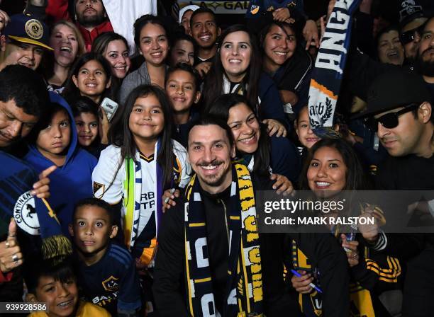 Football star Zlatan Ibrahimovic is greeted by fans after arriving at Los Angeles International Airport to begin his new contract with local club LA...