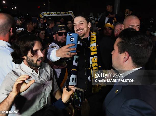 Football star Zlatan Ibrahimovic is greeted by fans after arriving at Los Angeles International Airport to begin his new contract with local club LA...