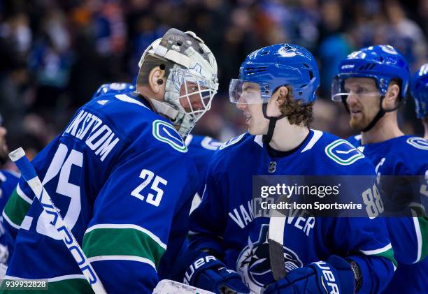 Vancouver Canucks Goalie Jacob Markstrom and Center Adam Gaudette celebrate their victory against the Edmonton Oilers at the end of a NHL hockey game...