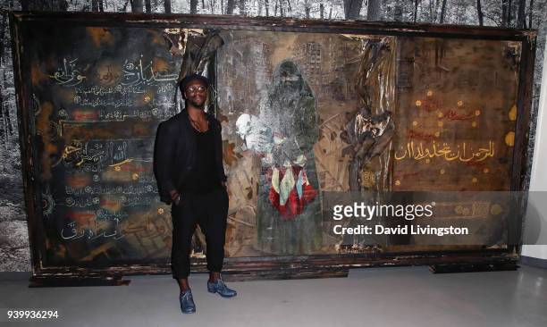 Actor/artist Aldis Hodge poses with his art at Art with a Cause hosted by Shaun Ross & Aureta benefiting the Freedom United Foundation for the...