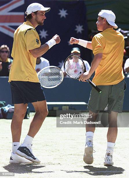 Lleyton Hewitt and Patrick Rafter of Australia celebrate winning a point against Cedric Pioline and Fabrice Santoro of France in the Davis Cup World...