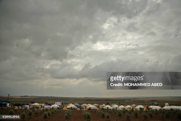 Picture taken on March 30, 2018 shows a view of a tent city along the border with Israel east of Jabalia in the Gaza strip erected to commemorate...