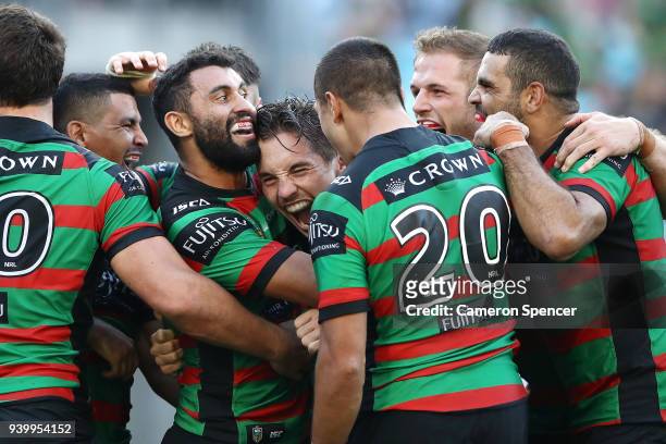 Cameron Murray of the Rabbitohs celebrates with team mates after scoring a try during the round four AFL match between the South Sydney Rabbitohs and...