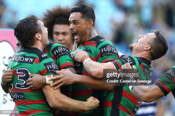 Cameron Murray of the Rabbitohs celebrates with John Sutton of the Rabbitohs and team mates after scoring a try during the round four AFL match...