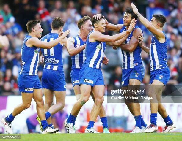 Ben Jacobs of the Kangaroos celebrates a goal with teammates during the round two AFL match between the North Melbourne Kangaroos and the St Kilda...