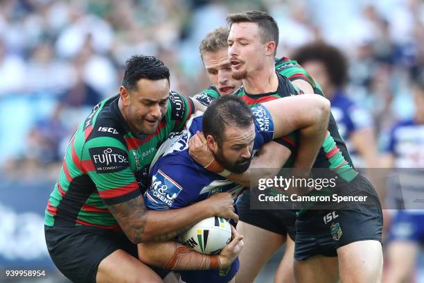 Aaron Woods of the Bulldogs is tackled during the round four AFL match between the South Sydney Rabbitohs and the Canterbury Bulldogs at ANZ Stadium...