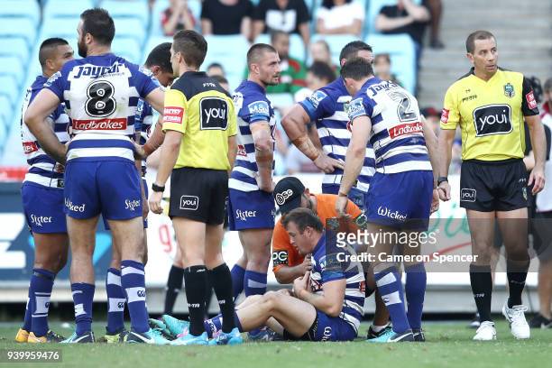 Josh Morris of the Bulldogs receives attention after receiving an elbow to the throat during the round four AFL match between the South Sydney...