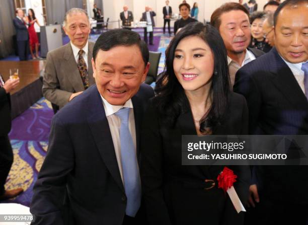 This photo received from Japan's Asahi Shimbun taken on March 29, 2018 shows former Thai prime ministers Thaksin Shinawatra and his sister Yingluck...