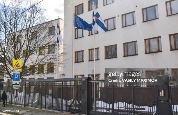 Picture taken on March 29, 2018 shows a woman walking past the embassy of Finland in Moscow. Russia on March 29, 2018 announced a mass expulsion of...