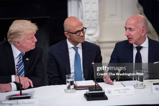 President Donald Trump speaks with Satya Nadella, Chief Executive Officer of Microsoft, and Jeff Bezos, Chief Executive Officer of Amazon during an...