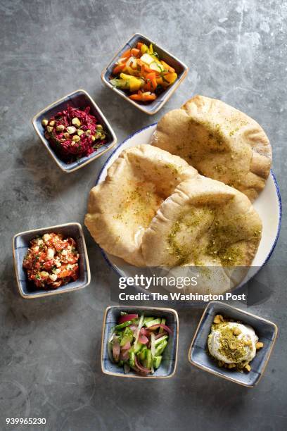 Salatim--from top counterclockwise: Carrot Salad with Dates and Mint, Beetroot Relish with Tahina and Pistachio; Roasted Red Pepper and Feta with...