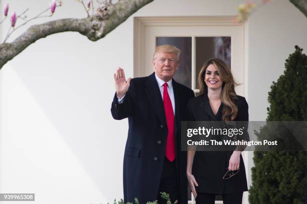 President Donald J. Trump waves beside White House Communications Director Hope Hicks as he walks from the Oval Office to board Marine One to depart...