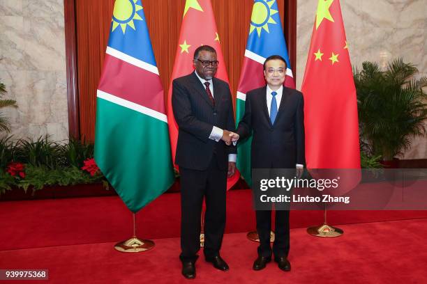 Chinese Premier Li Keqiang shakes hands with Namibia's President Hage G. Geingob at The Great Hall of People on March 30, 2018 in Beijing, China. At...