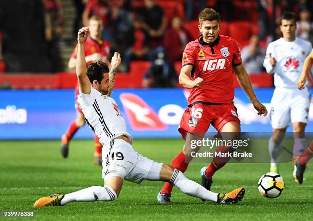 Thomas Doyle of Wellington Phoenix tackles Nathan Konstandopoulos of Adelaide United during the round 25 A-League match between Adelaide United and...