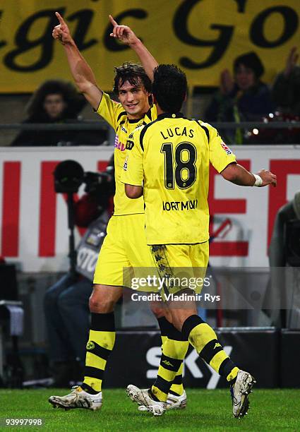 Mats Hummels celebrates with his team mate Lucas Barrios of Dortmund after scoring his team's fourth goal during the Bundesliga match between...