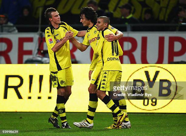 Mats Hummels celebrates with his team mates Kevin Grosskreutz and Mohamed Zidan of Dortmund after scoring his team's fourth goal during the...