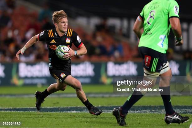 Chiefs Damian McKenzie makes abreak during the round seven Super Rugby match between the Chiefs and the Highlanders at FMG Stadium on March 30, 2018...