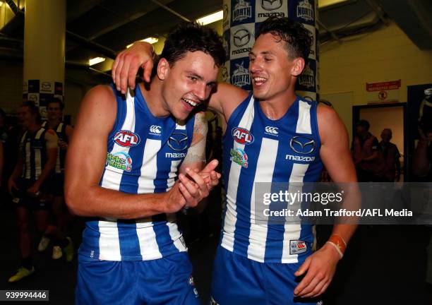 Luke Davies-Uniacke of the Kangaroos celebrates his first win with Ben Jacobs of the Kangaroos during the 2018 AFL round 02 Good Friday Kick for the...